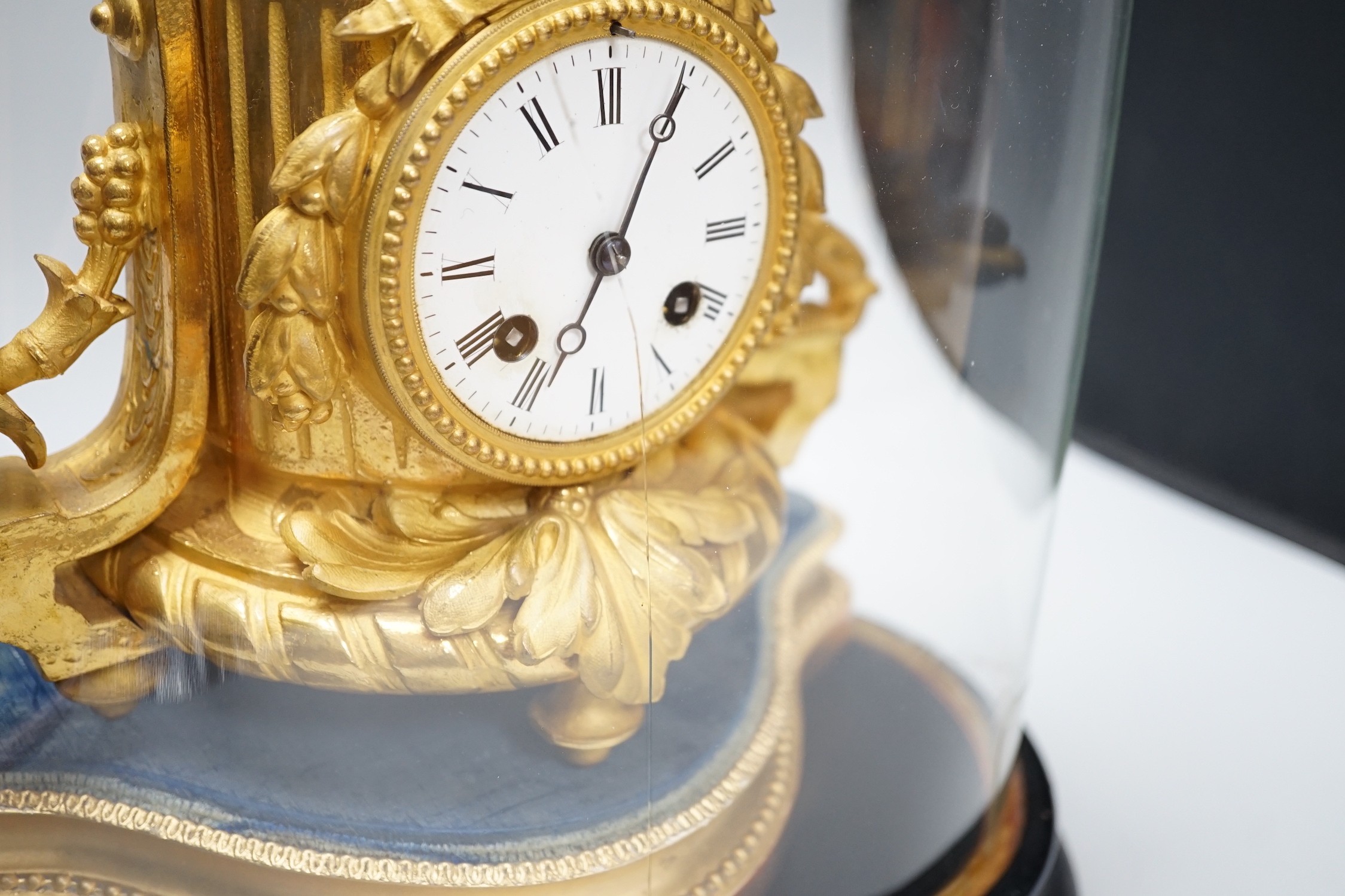 A French 19th century gilt metal clock by Phillipe H. Mourey on stand with glass dome, total height 49cm (dome a.f.)